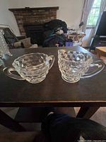 front view of creamer and sugar showing cube pattern and handles