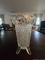 Full view of vase showing diamond point body, open lace rim, and three feet