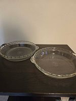 Two clear glass Pyrex pie plates on table top