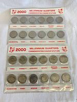 Front view of three plastic holders showing rows of commemorative quarters with theme labels