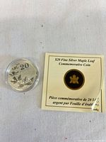 Coin in capsule beside specification folder front
