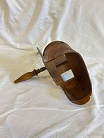 Side view showing curved eye hood, card stage and handle