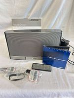 Front view of Bose SoundDock with manuals, remote, dock inserts, power adapter visible