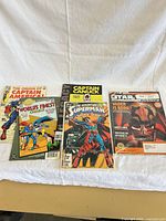 Group shot of all five comics and magazines laid out