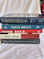 Spine view of all five stacked books showing titles and formats