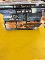 Stack of five paperback books showing titles on spines