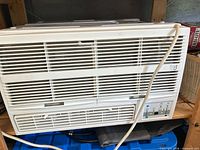 Front view showing full unit, grille, controls, and power cord