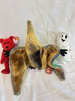 Three Ty Beanie Babies grouped: Swoop pterodactyl front, Osito bear left, Sheets ghost right