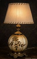 Full view of lamp illuminated with hand-laced parchment shade attached