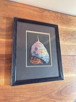 Framed artwork hung on wood wall showing overall piece