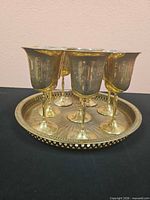 Goblets displayed on tray showing engraved designs