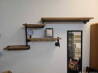Full view of four-tier wall shelf mounted on wall