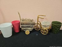 Five types of planters lined up showing sizes, materials and colors