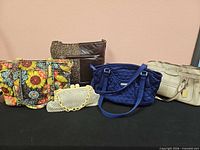 Group shot of five handbags on table