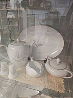 Teapot, platter, sugar bowl, creamer, salt & pepper shakers in cabinet