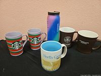 Full set of five mugs and one tumbler displayed