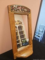 Front view showing full oak mirror with painted panel and shelf