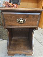 Front view showing drawer, open shelf, hardware, color and wear