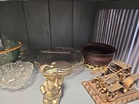 Group view showing green pressed glass bowl, wire basket, bronze-tone bowl, clear glass dish and metal car sculpture
