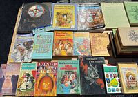 Top-down view of first group of books showing titles, cover art and wear.