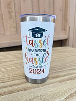 Front graphic of tumbler showing graduation text and design