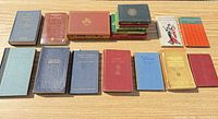 All 17 books displayed in two rows on tabletop