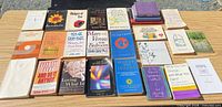 Full lot of 26 books on table