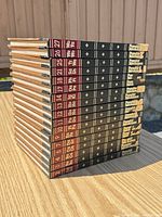17 hardcover volumes stacked, showing spines with volume numbers and ex-library stickers
