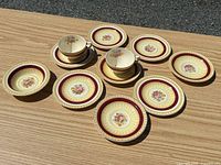 Full set laid out: 2 cups, 8 saucers, 1 bowl