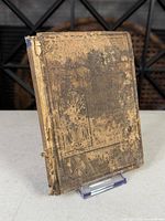 Front cover showing extensive cloth loss and wear