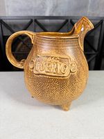 Full side view of pitcher showing raised Jose Cuervo logo, handle and spout