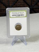 Front of slabbed coin showing grading label and coin