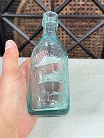 Front view showing embossed "JACKSON'S MALTA SODA" text and overall color