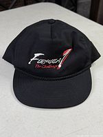 Front view showing "Formula 1 The Challenge" embroidery and braided rope trim