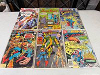 All six bagged DC comics laid out in two rows on table