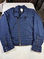 Front view of Diesel blue plaid moto jacket showing zipper, pockets and overall design