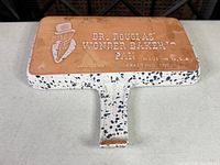 Underside view showing Dr. Douglas Wonder Baker Pan branding and wear