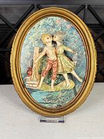 Front view of oval framed relief plaque
