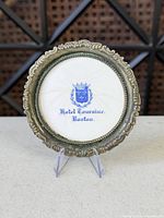 Front view showing crest, porcelain insert, ornate rim