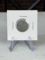 Front of coin in 2x2 holder on stand