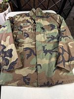 Front view of woodland camouflage field jacket showing overall design and pattern