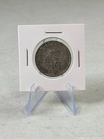 Obverse of coin in 2x2 flip showing hibiscus and denomination