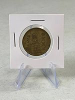 Obverse side of Mexican 50 Pesos coin in cardboard flip on stand