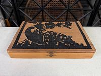 Closed wooden box showing stencil motif and latch