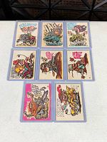 Full 3 × 3 layout of nine cards in sleeves