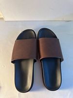 Top view of both slides showing brown straps and black footbeds