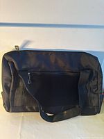 Front view of black Paco Rabanne duffel showing mesh panel and handles