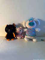 Group shot showing all three stuffed toys together for scale and condition
