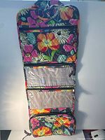 Bag fully unzipped showing hook, three clear zip compartments, bottom quilted pouch