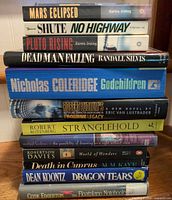 Stack of 12 novels showing titles and spines